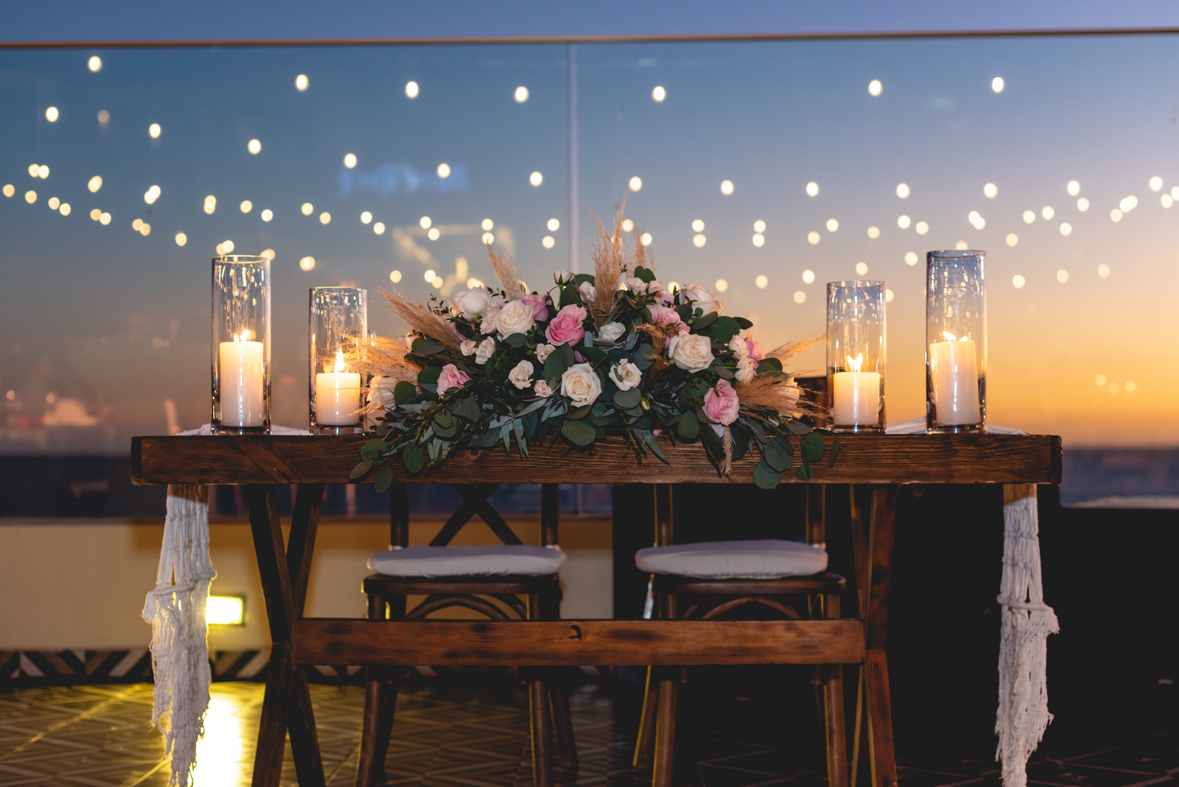 Wedding floral arrangement on a wooden table. With candles, very classy and luxurious.