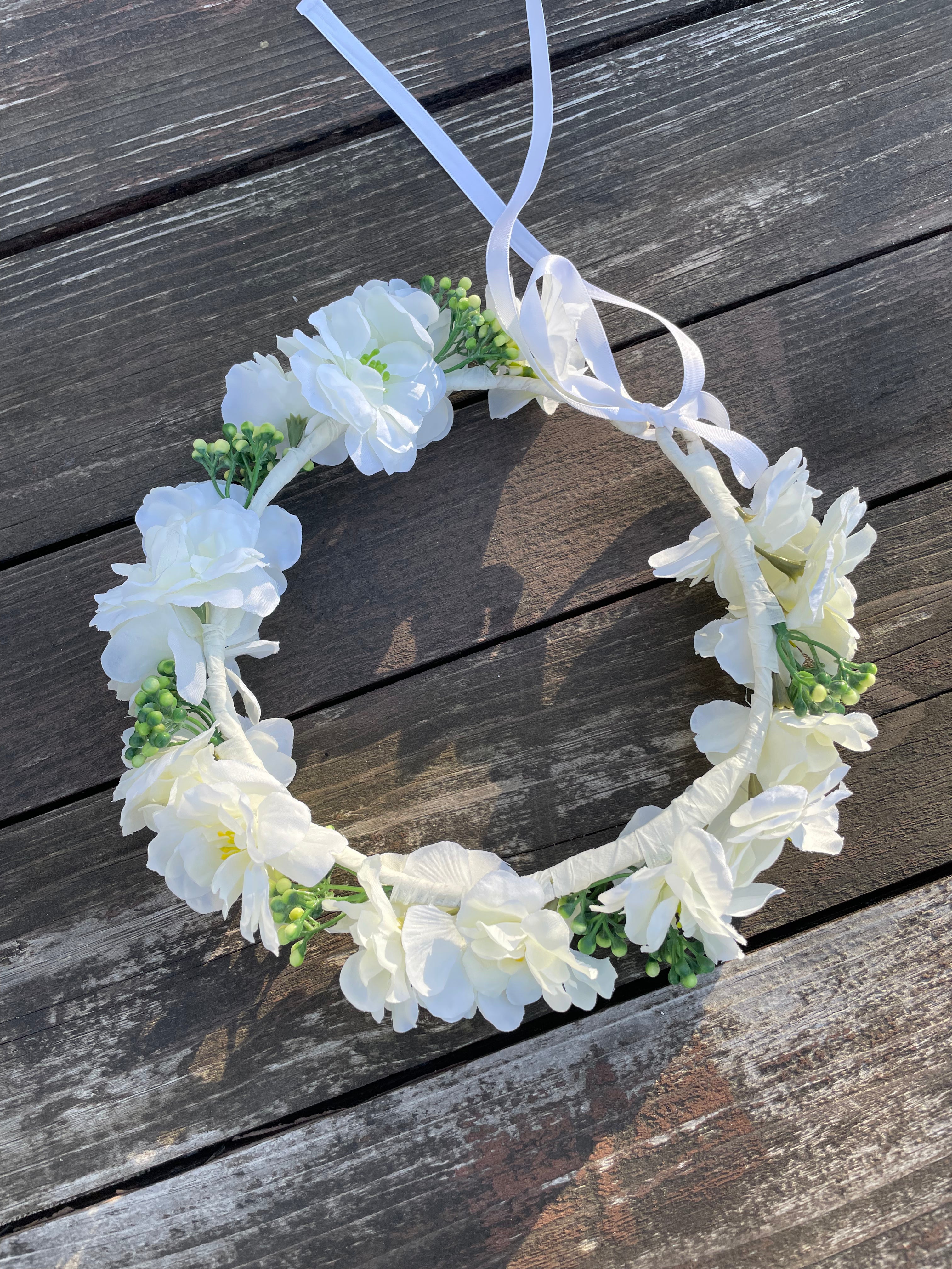 White floral crown on a wooden surface