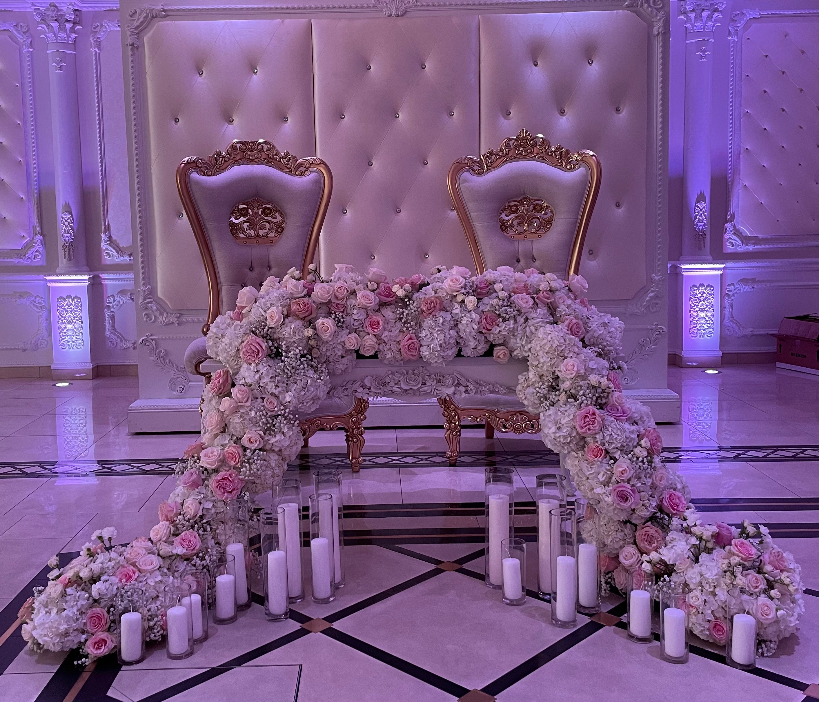 Decorative floral arch with chairs in a grand hall